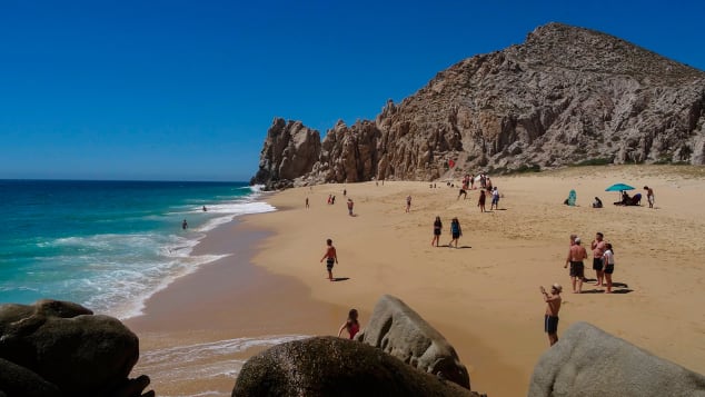 Tourists sunbathe at the 'Love Beach' in Los Cabos, Baja California Sur state, Mexico in March, 2018.