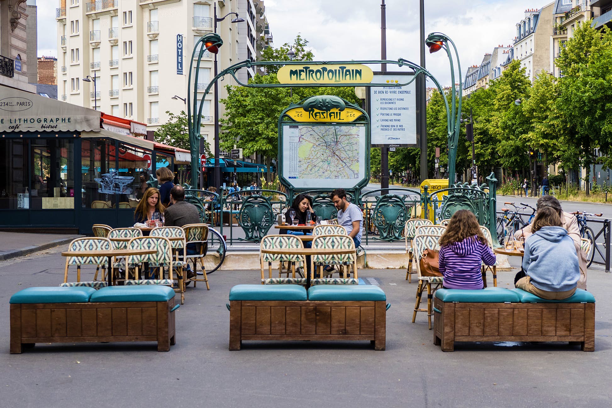 People sit at a terrace in front of the Raspail metro station in the 14th arrondissement of Paris, as bars and restaurants reopen after two months of nationwide restrictions ©Edward Berthelot/Getty Images