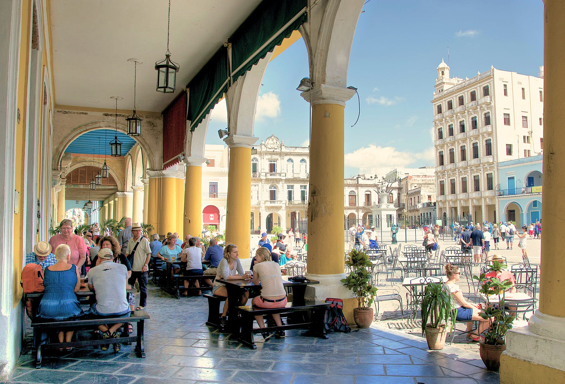 Visitors sitting at a cafe in Plaza Vieja (Old Square): tourism is the mainstay of the Cuban economy © Alarax/Shutterstock